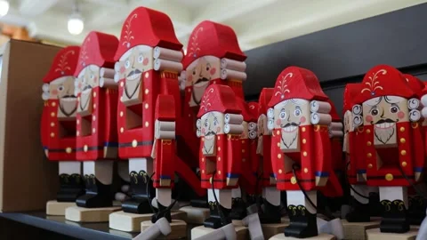 Row of wooden nutcrackers displayed on a shelf, ideal for decorating homes and Stock Footage 322534691