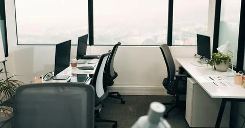 Row, workstation and desk with computer in office, programming department and Stock-Fotos