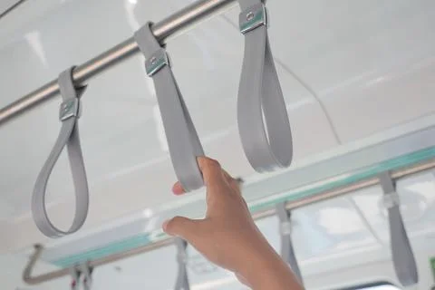 A row of yellow handle on a bus Photos