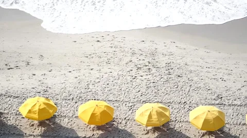 Row of Yellow Umbrellas on Beach Stock Footage 262396836
