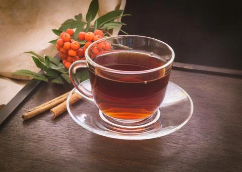 Rowan berries, cup of tea and cinnamon Stock Photos