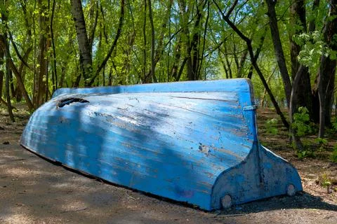 Rowboat with a broken side. Stock Photos