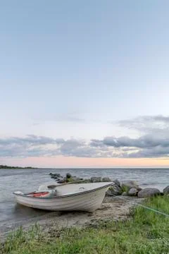 Rowboat by Ocean at Sunset Stock Photos