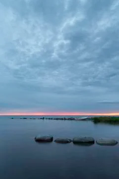 Rowboat by Ocean at Sunset 스톡 사진