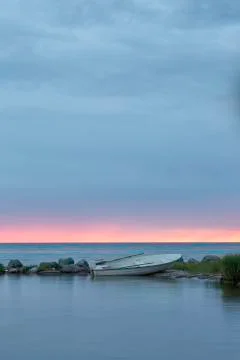 Rowboat by Ocean at Sunset Stock Photos