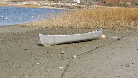 Rowboat on sand, day. Video stock 105867189