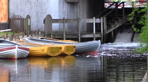 Rowboats for rent reflected in the stream, weir and passage Video stock 49595404