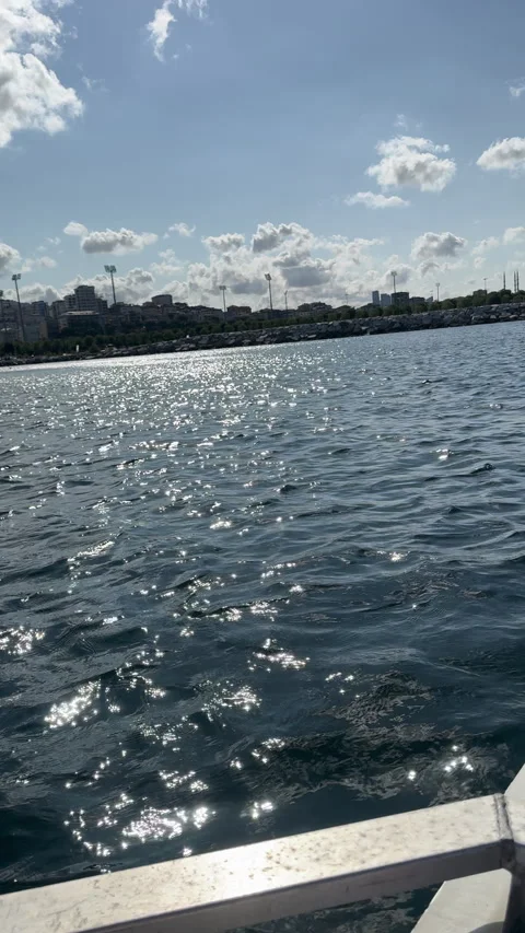 Rower gliding through water with urban skyline backdrop, Italy 動画素材 327489261