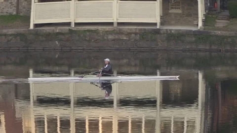 Rower on schuylkill river with boat house row, philadelphia Stock Footage 84189786