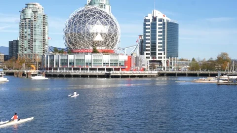 Rowers paddle towards science world Stock Footage 120322653
