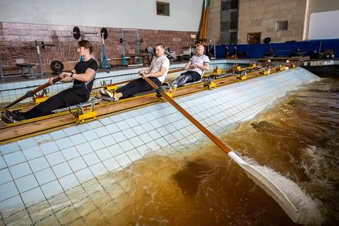 Rowing athletes skillfully manipulate oars, refining synchronization on rowing Stock Photos