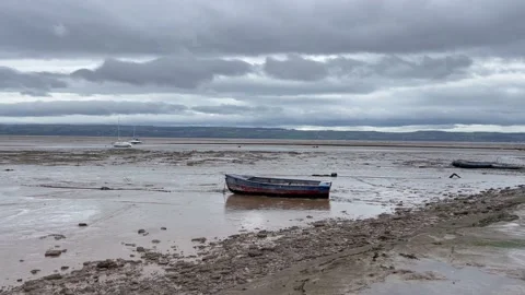 Rowing boat beach low tide sea moody Stock Footage 237994989