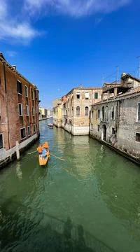 A rowing boat in a canal in Venice. Stock Photos