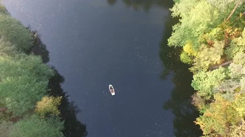 A rowing boat floats on the the river in the forest. Aerial view. Stock-Footage 68352766
