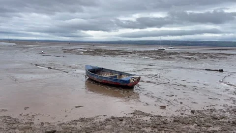 Rowing boat low tide sand sea storm Stock Footage 244719299