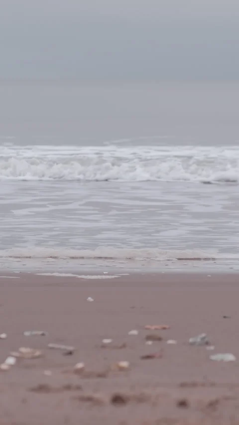 Rowing boat moving on horizon on a cloudy morning at Portobello Beach in Stock Footage 325849701