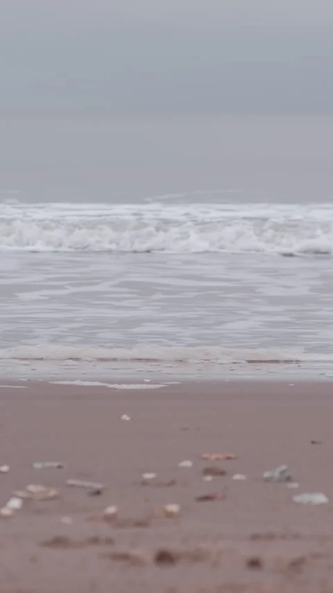 Rowing boat moving on horizon on a cloudy morning at Portobello Beach in Stock Footage 325849875
