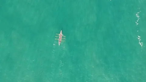 Rowing boat rowing over bright blue water in Port Isaac, Cornwall, England Stock Footage 94482882