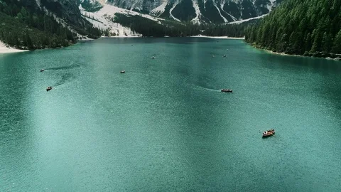 Rowing boats floating on a famous alpine lake Lago di Braies. Tourism mecca Stock Footage 119357941