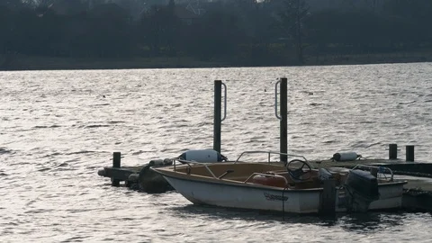 Rowing boats tied up to a dock during the cold winter months in Hornsea Stock Footage 123972015