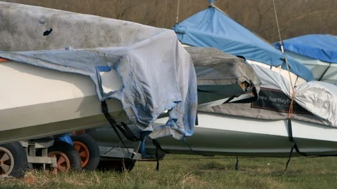 Rowing boats under cover during the winter months in very windy weather, Hornsea Stock Footage 123971796