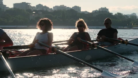 Rowing crew in a shell training together on the sea during a sunny summer Stock Footage 344642223
