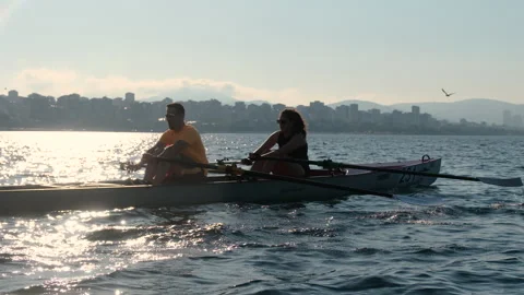Rowing crew in a shell training together on the sea during a sunny summer Stock-Footage 344642615