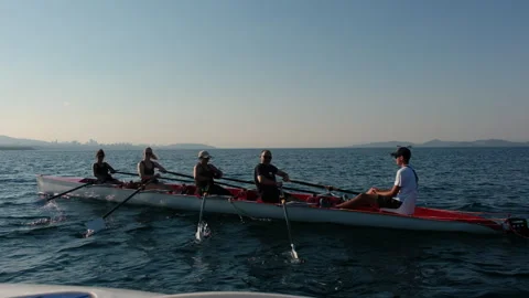 Rowing crew in a shell training together on the sea during a sunny summer Stock-Footage 344643267