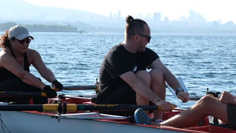 Rowing crew in a shell training together on the sea during a sunny summer Stock-Footage 344643289