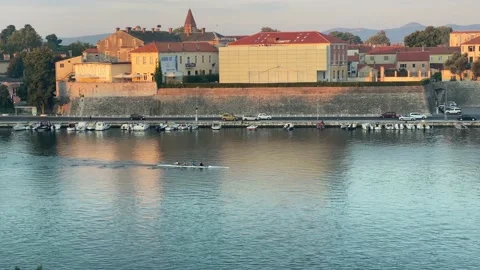 Rowing crew at sunrise by Zadar Old City Vidéo 163664560