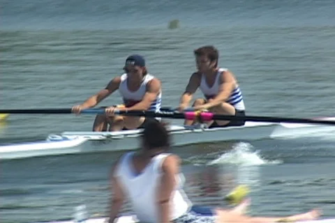 Rowing crew two man- pan follows from race start Stock Footage 125498290