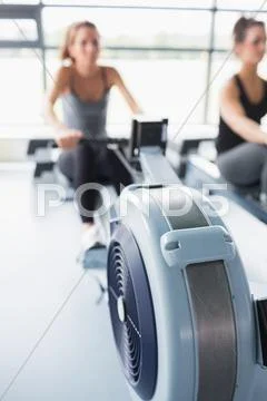 Rowing machine being used in gym Stock Photos