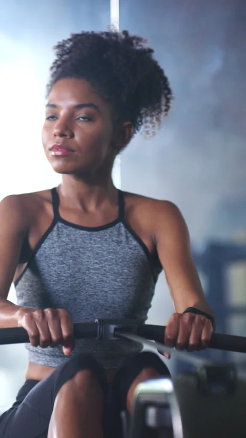 Rowing machine, fitness and training with woman in gym for workout, cardio Stock Footage 324172600