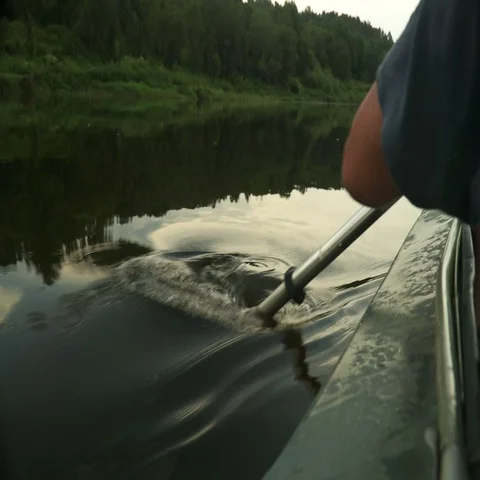Rowing a paddle in the calm water of the river Stock Footage 69481954