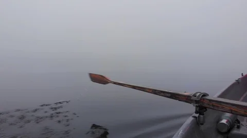 Rowing paddle vacuum flask in dense fog small boat lake in Finland Stock Footage 119665650