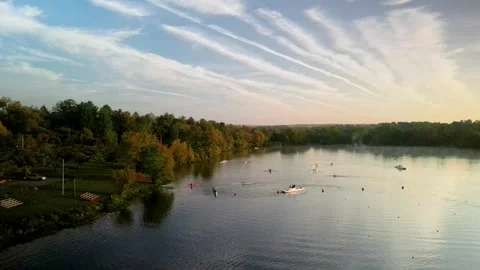 Rowing practice with many skiffs on a calm lake at sunrise Stock Footage 287361317