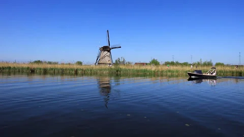 Rowing in the river near the windmill Stock Footage 147871658