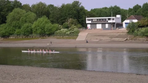 Rowing Team and Motorboat Pass Cygnet Rowing Club on a Calm Day Stock Footage 336462532