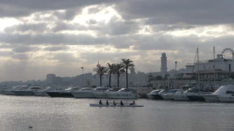 Rowing team in boat rowing together in the sea Stock Footage 134706396