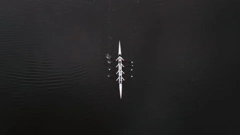 Rowing team practices on a calm river during the early morning hours Stock Footage 336500693