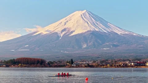 Rowing team practices on lake with Mount Fuji in background at sunrise. Stock Footage 339640074