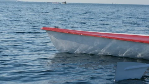 Rowing team sculling in a racing boat during training on the blue water Stock Footage 344643268