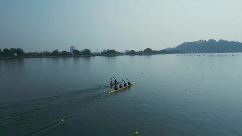 Rowing Team Training on Calm Lake with Competitive Water Sports Activity Stock Footage 327796009
