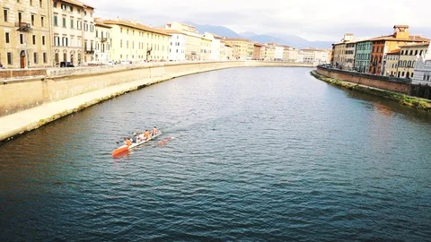 Rowing team training on a river in Florence, teamwork and endurance Stock Footage 99864851