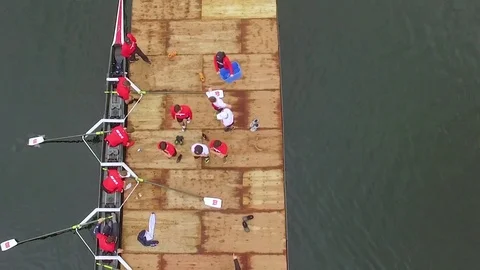 Rowing team unloading from boat onto dock, overhead aerial Stock Footage 85192444
