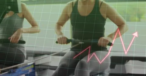 Rowing two athletic women pulling grips and pushing foot straps at gym studio, Stock Photos