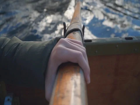 Rowing wooden paddle close up view with a boat moving through the water Stock Footage 104674869