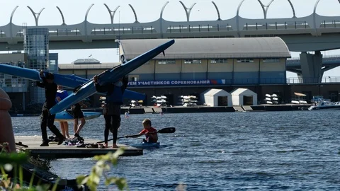 ROWING: Young athletes take out their kayaks from a water 스톡 동영상 120769541