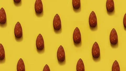 Rows of almonds on a yellow background Stock Photos