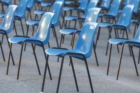 Rows and columns of nondescript blue plastic chairs, Spain. Stock Photos